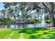 Community entrance sign surrounded by beautiful landscaping and a serene pond with a fountain at 5217 Chase Oaks Dr, Sarasota, FL 34241