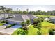 A well-maintained home featuring a two car garage, lush landscaping, and verdant lawn at 5217 Chase Oaks Dr, Sarasota, FL 34241