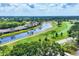 Scenic view of a golf course with a tranquil pond and a paved path at 5217 Chase Oaks Dr, Sarasota, FL 34241