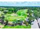 Scenic aerial view of the golf course with lush greenery, sand traps, and blue skies at 5217 Chase Oaks Dr, Sarasota, FL 34241