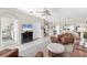 Open-concept living room with tile floors, leather seating, and access to other rooms at 5217 Chase Oaks Dr, Sarasota, FL 34241