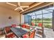 Relaxing screened-in patio with ceiling fan, comfortable seating, and a beautiful water view at 5217 Chase Oaks Dr, Sarasota, FL 34241