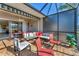 Cozy screened-in patio with comfortable furniture, perfect for relaxation and outdoor dining at 5217 Chase Oaks Dr, Sarasota, FL 34241