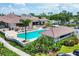This community pool features a Jacuzzi, shaded areas, and plenty of seating for relaxation and enjoyment at 5217 Chase Oaks Dr, Sarasota, FL 34241