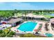 This community pool and patio includes a jacuzzi, covered seating, lounge chairs, and views of the golf course at 5217 Chase Oaks Dr, Sarasota, FL 34241