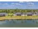 The back of the home displays screened lanais overlooking a serene lake at 5217 Chase Oaks Dr, Sarasota, FL 34241