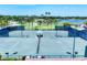 Well-maintained tennis courts with manicured green surroundings and a center shelter at 5217 Chase Oaks Dr, Sarasota, FL 34241