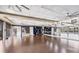 The large yoga studio features wood floors, mirrored walls, ceiling fans, storage shelves, and exercise equipment at 5217 Chase Oaks Dr, Sarasota, FL 34241