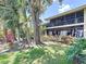 Scenic backyard showcasing lush foliage and mature trees with view of screened-in patio at 5234 Lake Arrowhead Trl # 30, Sarasota, FL 34231