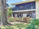 Spacious backyard with a screened-in patio, tropical landscaping, and mature trees at 5234 Lake Arrowhead Trl # 30, Sarasota, FL 34231