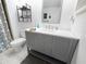 Bright bathroom with a gray vanity, modern fixtures, and decorative shelving at 5234 Lake Arrowhead Trl # 30, Sarasota, FL 34231
