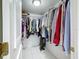 Walk-in closet features a full metal rack of clothing, and a tile floor at 5234 Lake Arrowhead Trl # 30, Sarasota, FL 34231