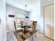 Dining room featuring a modern glass table with seating for four, and decorative rug at 5234 Lake Arrowhead Trl # 30, Sarasota, FL 34231