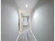 Hallway with light gray walls and wood-look floors leading to the front door at 5234 Lake Arrowhead Trl # 30, Sarasota, FL 34231