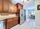 Kitchen features stainless steel appliances, wooden cabinetry, and an adjacent dining area at 5234 Lake Arrowhead Trl # 30, Sarasota, FL 34231