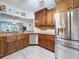 Kitchen with stainless steel appliances, wood cabinets, and granite countertops at 5234 Lake Arrowhead Trl # 30, Sarasota, FL 34231