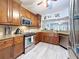 Kitchen with stainless steel appliances, wood cabinets, and granite countertops at 5234 Lake Arrowhead Trl # 30, Sarasota, FL 34231