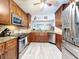 Kitchen with stainless steel appliances and warm wood cabinetry with bar at 5234 Lake Arrowhead Trl # 30, Sarasota, FL 34231