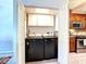 A laundry closet has new appliances with overhead cabinet storage, and kitchen view at 5234 Lake Arrowhead Trl # 30, Sarasota, FL 34231