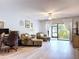 Open-concept living space with wood-look flooring, cozy furniture, and natural light at 5234 Lake Arrowhead Trl # 30, Sarasota, FL 34231