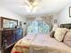 Inviting main bedroom featuring a large bed, a dark wood dresser, and access to the screened lanai at 5234 Lake Arrowhead Trl # 30, Sarasota, FL 34231