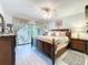 Spacious main bedroom featuring a large bed, a ceiling fan, and access to the home's lanai at 5234 Lake Arrowhead Trl # 30, Sarasota, FL 34231