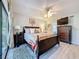 Bright main bedroom with a ceiling fan, large windows, and a TV for relaxing evenings at 5234 Lake Arrowhead Trl # 30, Sarasota, FL 34231