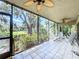 A screened-in patio with ceiling fans and a view of well-maintained landscaping and lush greenery at 5234 Lake Arrowhead Trl # 30, Sarasota, FL 34231