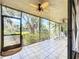 Enjoy the view in this screened-in patio with tile flooring, ceiling fans, and lush landscaping at 5234 Lake Arrowhead Trl # 30, Sarasota, FL 34231