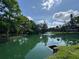 Picturesque pond with a fountain surrounded by lush greenery, offering a tranquil view at 5234 Lake Arrowhead Trl # 30, Sarasota, FL 34231