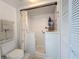 Bright white bathroom showcasing a walk-in tub with a shower and a matching white toilet and sink at 5234 Lake Arrowhead Trl # 30, Sarasota, FL 34231