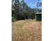 Spacious backyard with a storage shed and covered area, perfect for outdoor activities and gatherings at 6013 Idle A While Cir, Dade City, FL 33523
