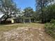 The back exterior of the house, with a view of the expansive yard and surrounding trees at 6013 Idle A While Cir, Dade City, FL 33523