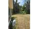 Side view of the home with ample yard space, showcasing the property's outdoor potential at 6013 Idle A While Cir, Dade City, FL 33523