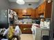 Functional kitchen with wood cabinets, stainless steel appliances, and ample countertop space at 6013 Idle A While Cir, Dade City, FL 33523