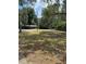 View of a grassy property, showcasing the land and its potential for various uses at 6013 Idle A While Cir, Dade City, FL 33523