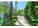 Lush backyard oasis with tropical plants and a charming bench, perfect for relaxation and enjoying nature at 6102 Sonesta Ct, Bradenton, FL 34202