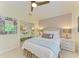 This bedroom features mirrored closet doors, a ceiling fan, and a soft, neutral color palette at 6102 Sonesta Ct, Bradenton, FL 34202