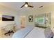A bedroom featuring a mirrored closet, a TV, and a desk with a rolling chair at 6102 Sonesta Ct, Bradenton, FL 34202