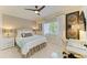 This bedroom features a ceiling fan, window with wooden shutters, and a desk with a glass top at 6102 Sonesta Ct, Bradenton, FL 34202