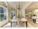 Bright dining room featuring a chandelier, large windows, and seating for four at 6102 Sonesta Ct, Bradenton, FL 34202