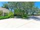 Long driveway leading to a beautiful home, showcasing a lush landscaped garden and mature trees at 6102 Sonesta Ct, Bradenton, FL 34202