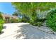 Long driveway leads to house with manicured trees, plants and landscape near an ornamental tiered fountain at 6102 Sonesta Ct, Bradenton, FL 34202