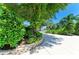 Concrete driveway lined with lush landscaping and mature trees leading to the house at 6102 Sonesta Ct, Bradenton, FL 34202