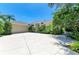 Spacious home showcasing a large driveway, a two-car garage and mature tropical landscaping at 6102 Sonesta Ct, Bradenton, FL 34202
