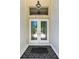 Inviting front entrance featuring double doors, stylish door hardware, and a modern black and white rug at 6102 Sonesta Ct, Bradenton, FL 34202