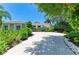 Attractive single Gathering home with manicured landscaping, mature trees, and a long driveway at 6102 Sonesta Ct, Bradenton, FL 34202