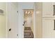 This hallway leads to a laundry room with a modern chandelier and a washer and dryer at 6102 Sonesta Ct, Bradenton, FL 34202