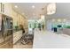 Open-concept kitchen featuring stainless appliances, island with quartz countertop, and seamless flow to living area at 6102 Sonesta Ct, Bradenton, FL 34202
