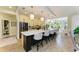 Large kitchen island with bar stools adjacent to a bright dining area at 6102 Sonesta Ct, Bradenton, FL 34202